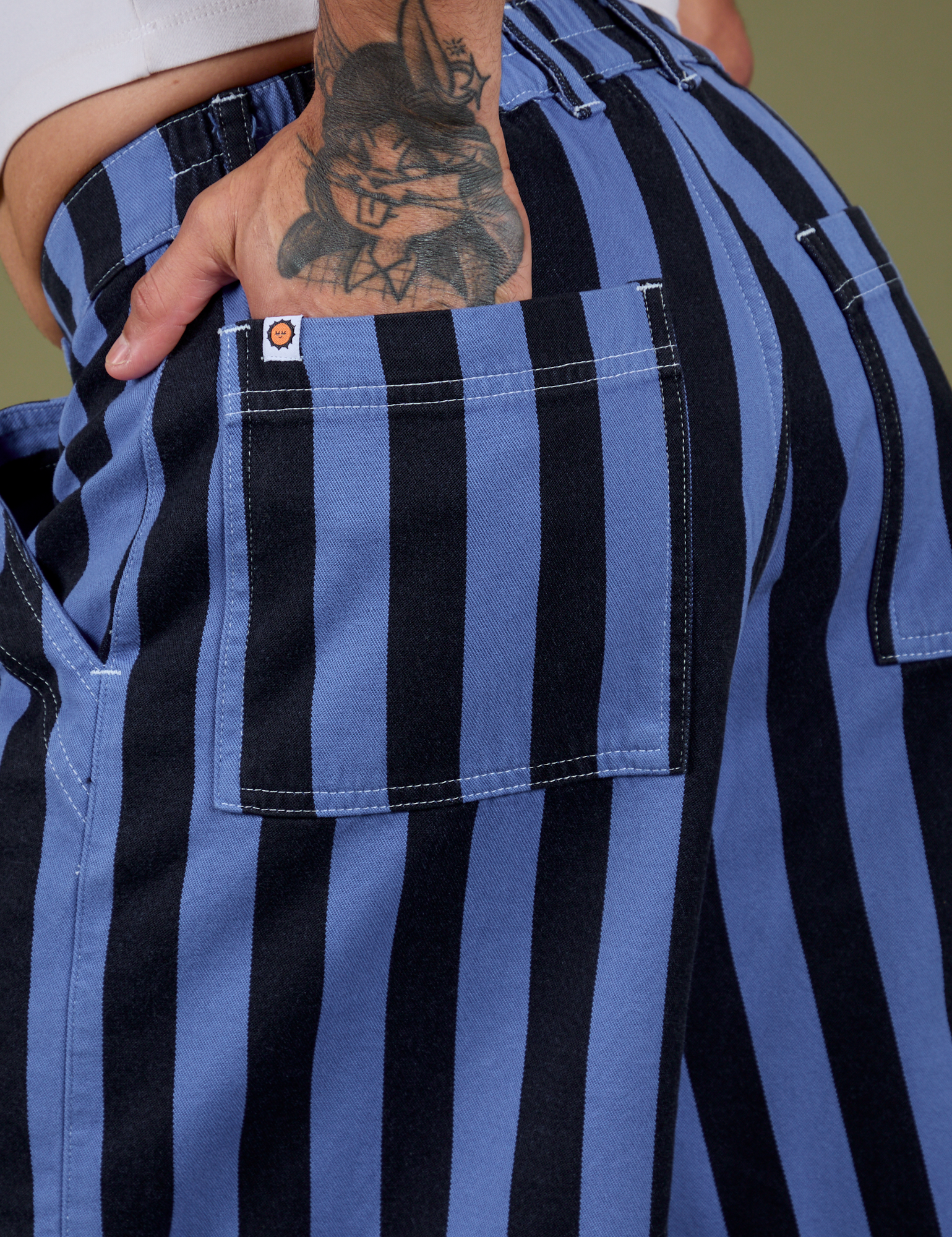 Close up of Jesse's hand in the back pocket of Longline Work Shorts in Cornflower