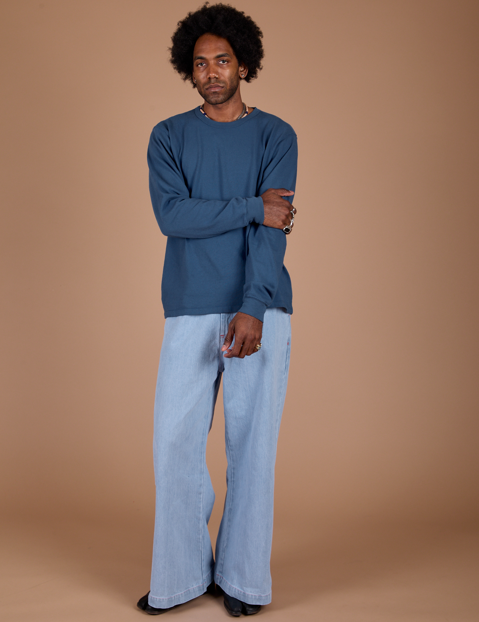 Jerrod is wearing Long Sleeve Burly Tee in French Blue and light wash Indigo Wide Leg Trousers