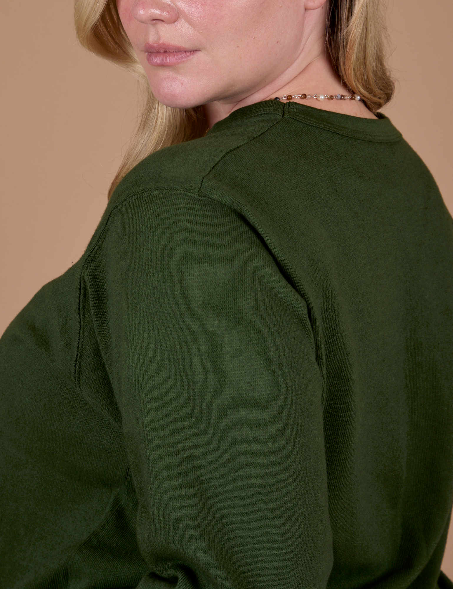 Side shoulder close up of Long Sleeve Burly Tee in Evergreen on Lish