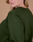 Side shoulder close up of Long Sleeve Burly Tee in Evergreen on Lish