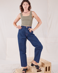 Alex is wearing Square Neck Tank in Khaki Grey and dark wash Denim Trousers