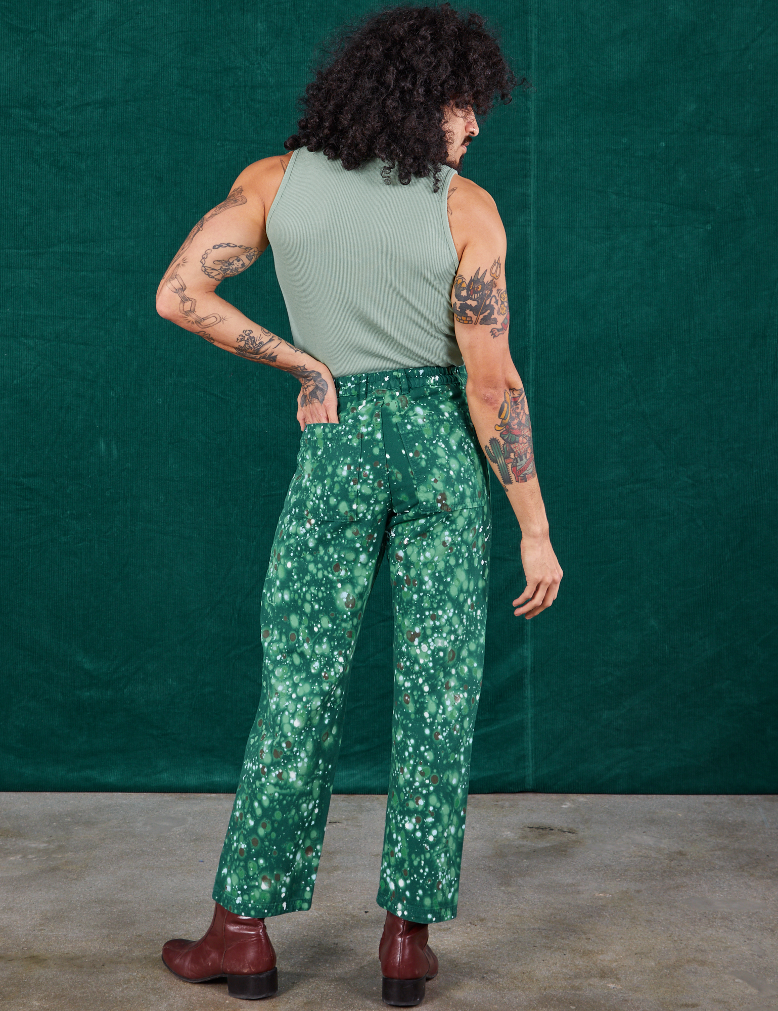 Back view of Marble Splatter Work Pants in Hunter Green and sage green Sleeveless Turtleneck on Jesse