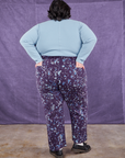 Back view of Marble Splatter Work Pants in Nebula Purple and baby blue Long Sleeve Fisherman Polo on Sam