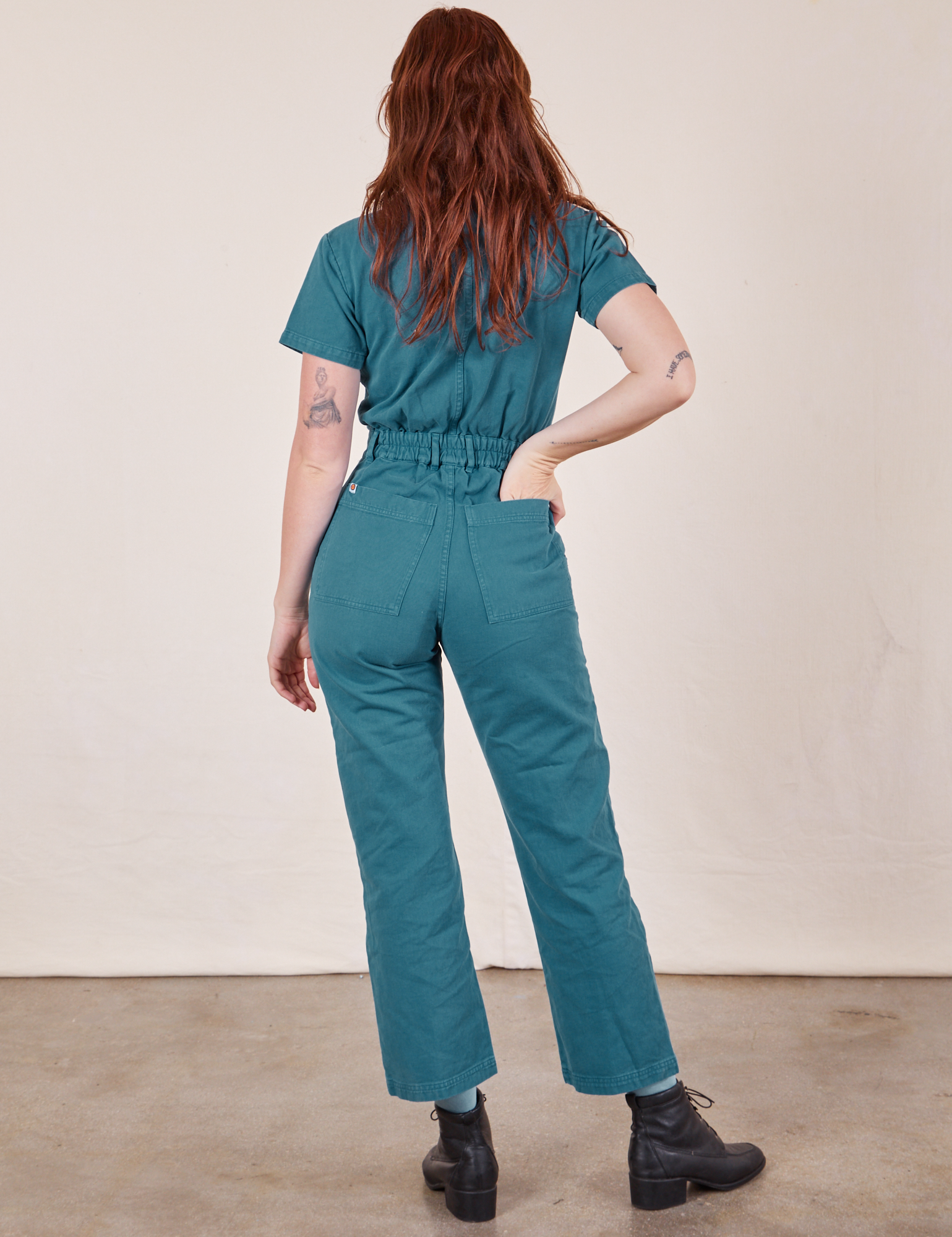 Back view of Short Sleeve Jumpsuit in Marine Blue worn by Alex