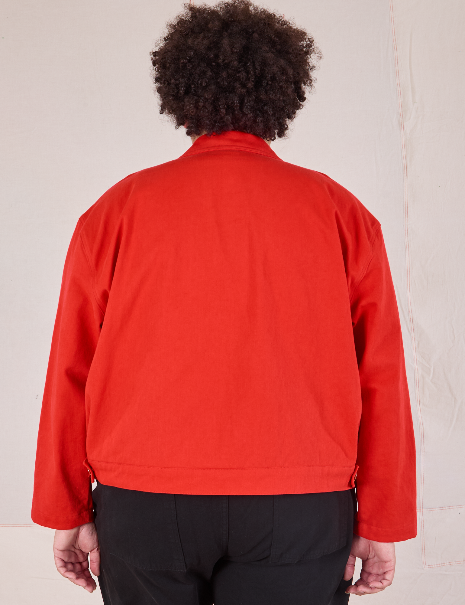 Mechanic Jacket in Mustang Red back view on Miguel