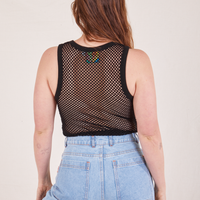 Back view of Mesh Tank Top in Basic Black and light wash Sailor Jeans worn by Allison