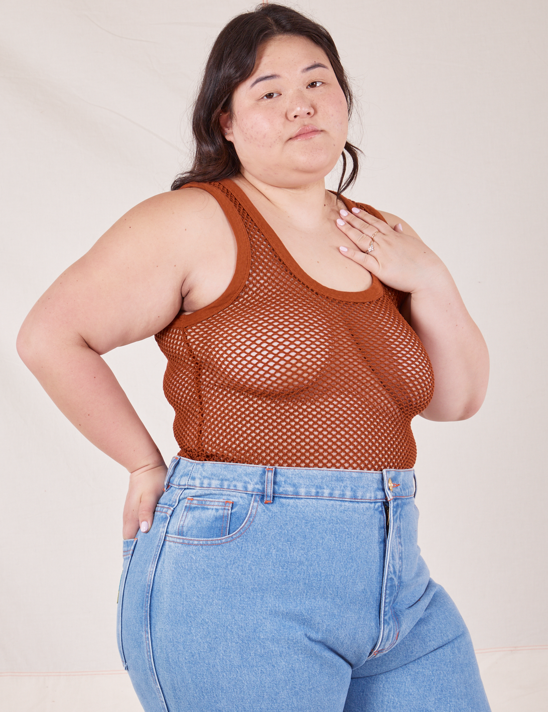 Angled view of Mesh Tank Top in Burnt Terracotta and light wash Frontier Jeans worn by Ashley