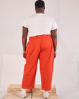 Back view of Mid-Rise Pleated Trousers in Chili Red and Organic Vintage Tee in vintage tee off-white on Elijah