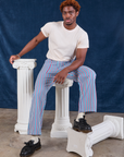 Issac is wearing Stripe Work Pants in Blue Raspberry and Organic Vintage Tee in vintage tee off-white