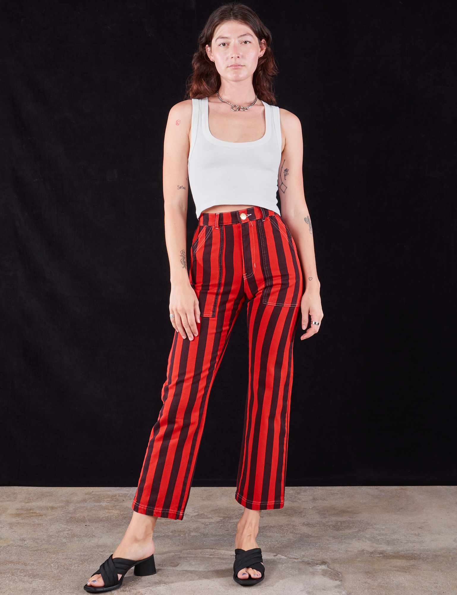 Alex is 5&#39;8&quot; and wearing XS Black Stripe Work Pants in Mustang Red paired with a Cropped Tank in vintage tee off-white