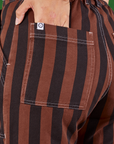 Black Stripe Work Pants in Fudgesicle Brown back view with Tiara's hand in the pocket.