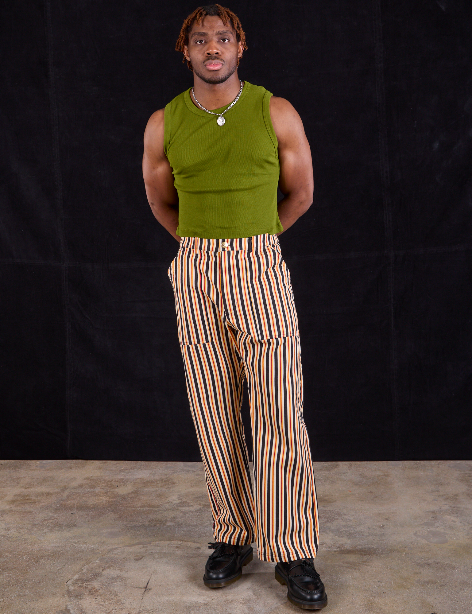 Issac is 5&#39;10&quot; and wearing M Work Pants in Autumn Stripe paired with summer olive Muscle Tee