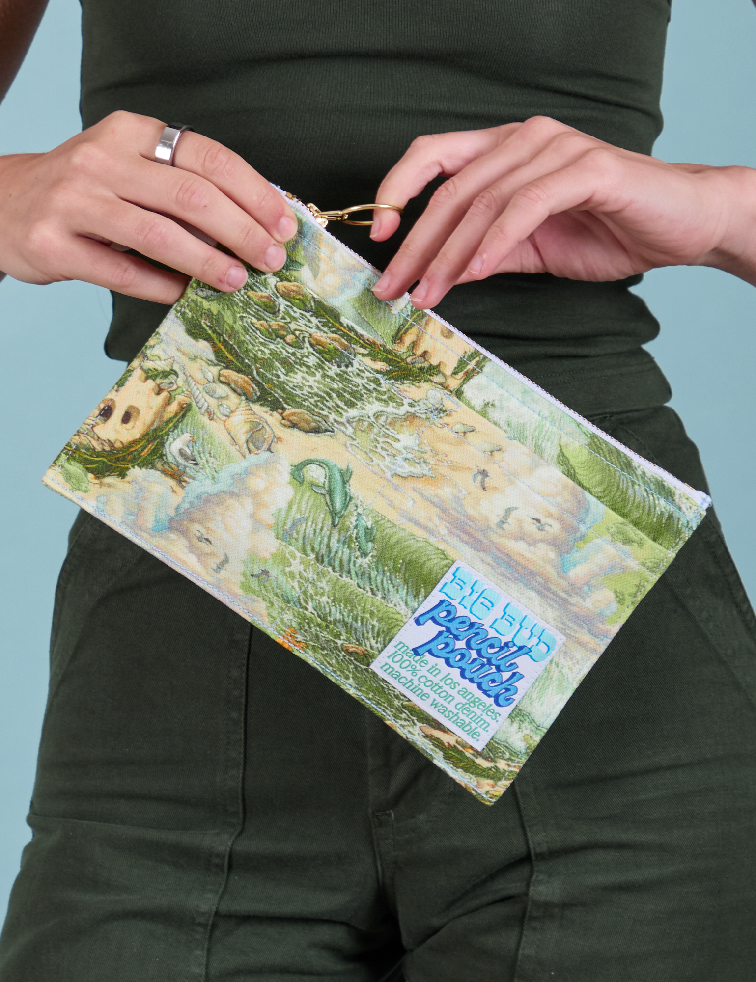 Ocean and Sky Printed Pencil Pouch held by Alex
