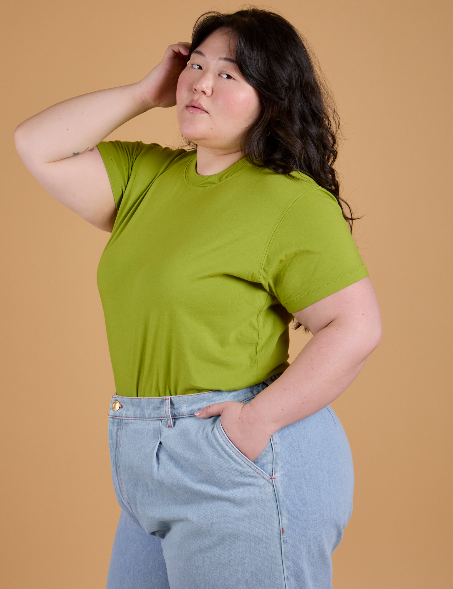 Angled front view of Organic Vintage Tee in Gross Green on Ashley