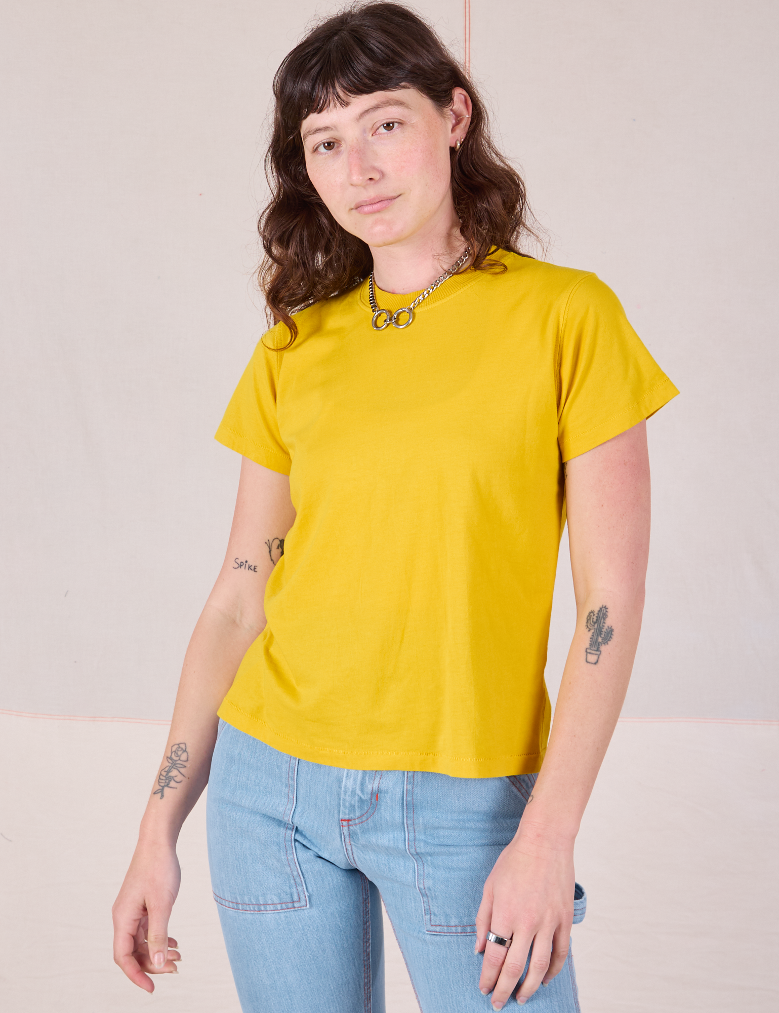 Alex is 5’8” and wearing P Organic Vintage Tee in Golden Yellow