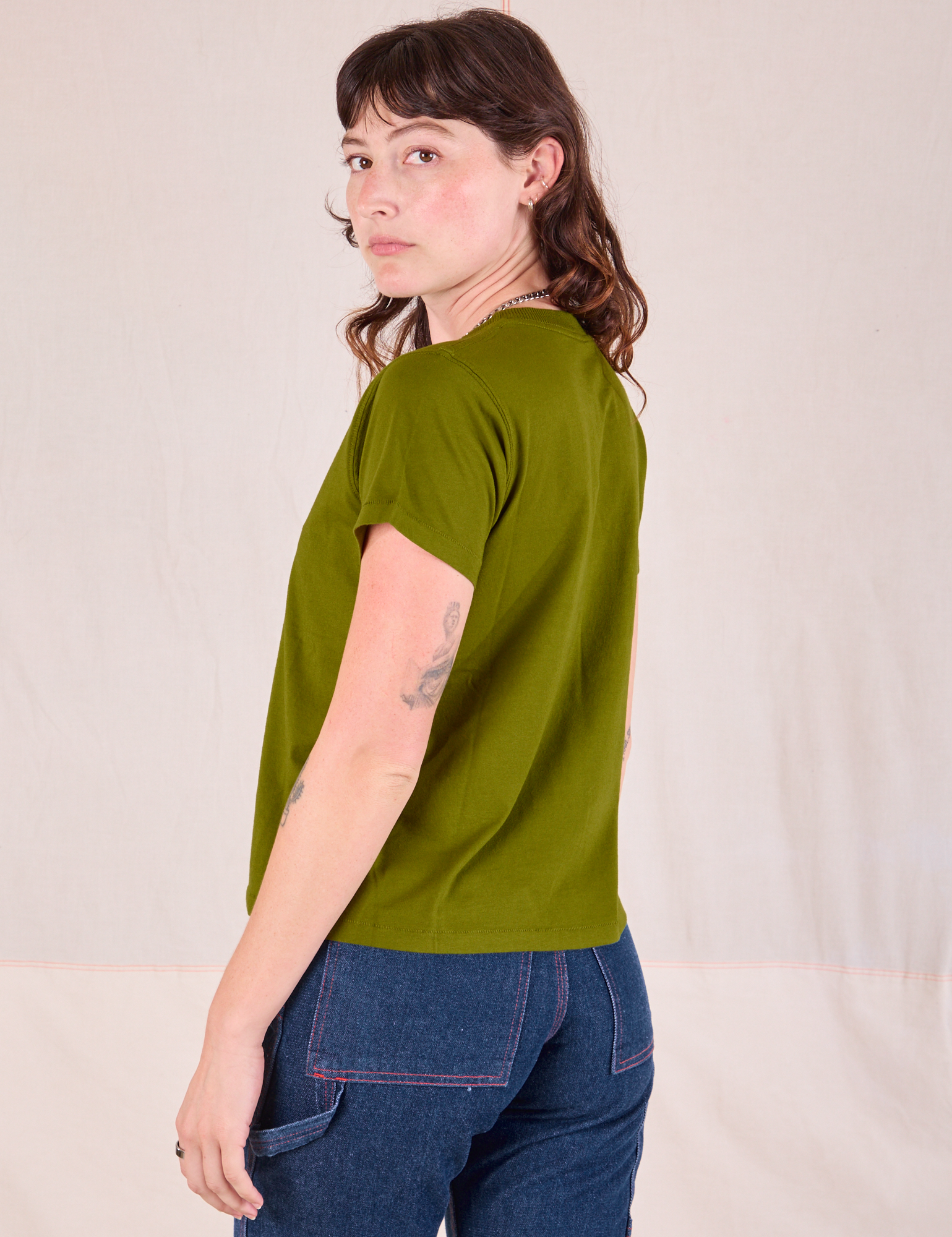 Organic Vintage Tee in Summer Olive angled back view on Alex