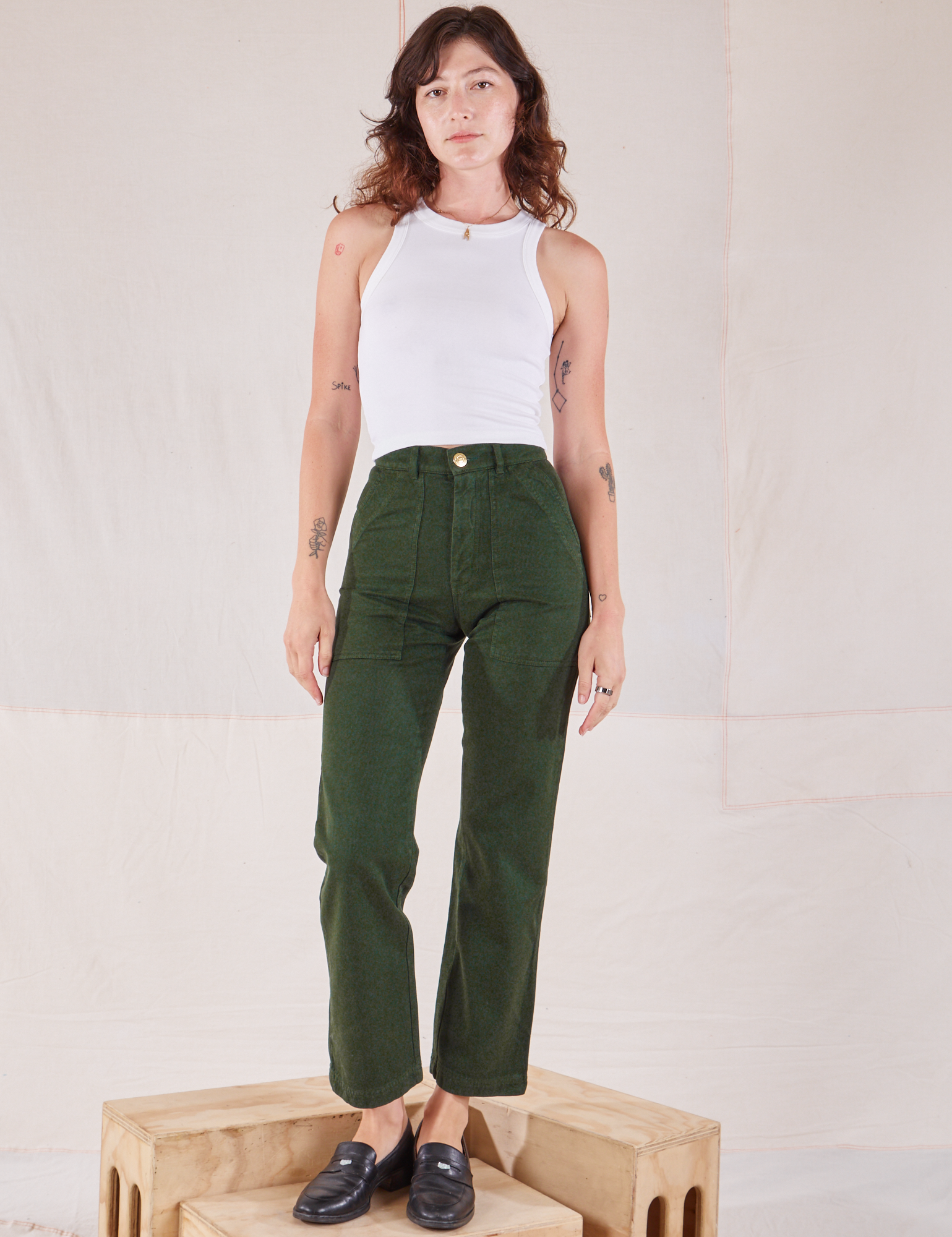 Alex is 5&#39;8&quot; and wearing XXS Organic Work Pants in Swamp Green   paired with Racerback Tank in vintage tee off-white