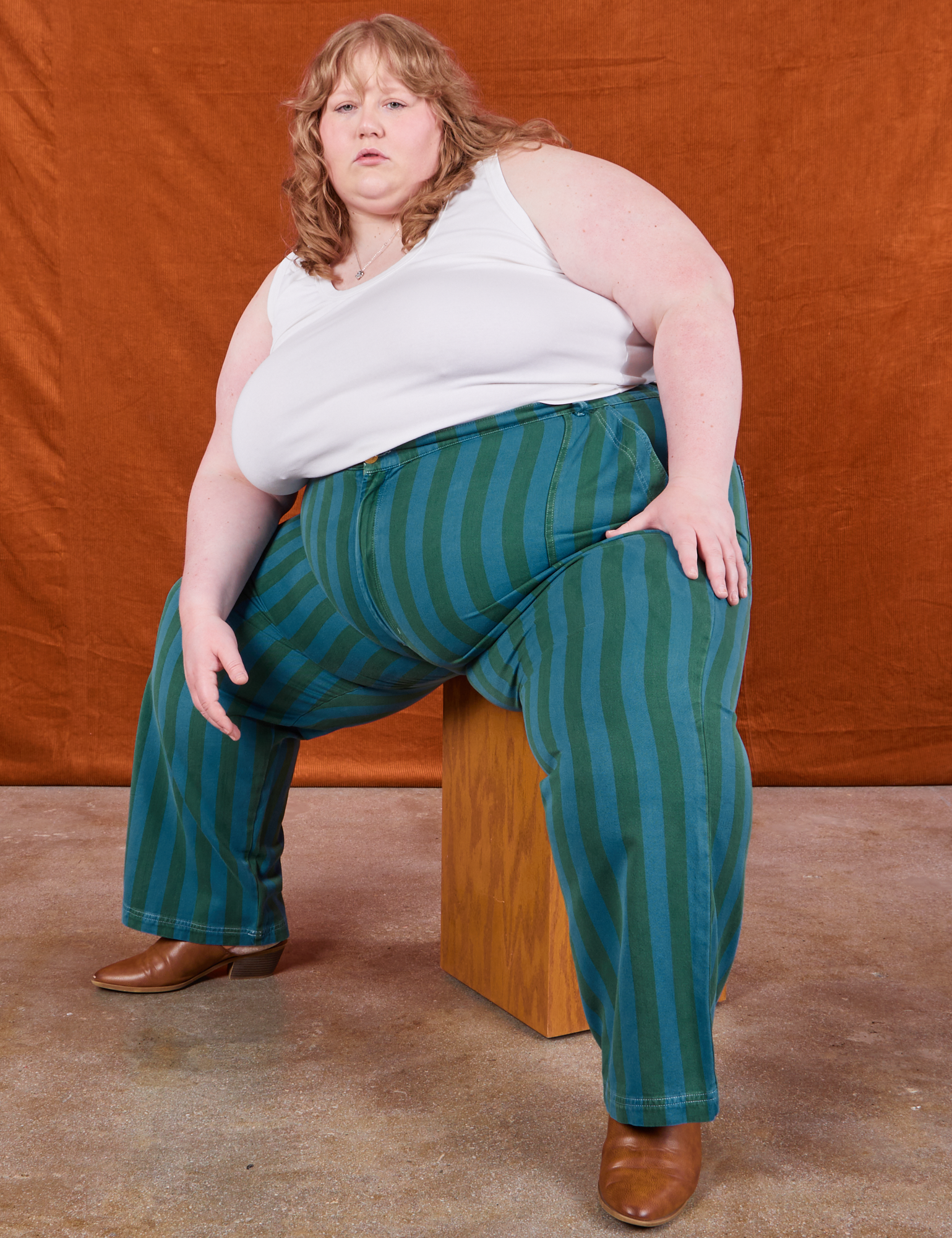 Catie is wearing Overdye Stripe Work Pants in Blue/Green and vintage off-white Cropped Tank Top