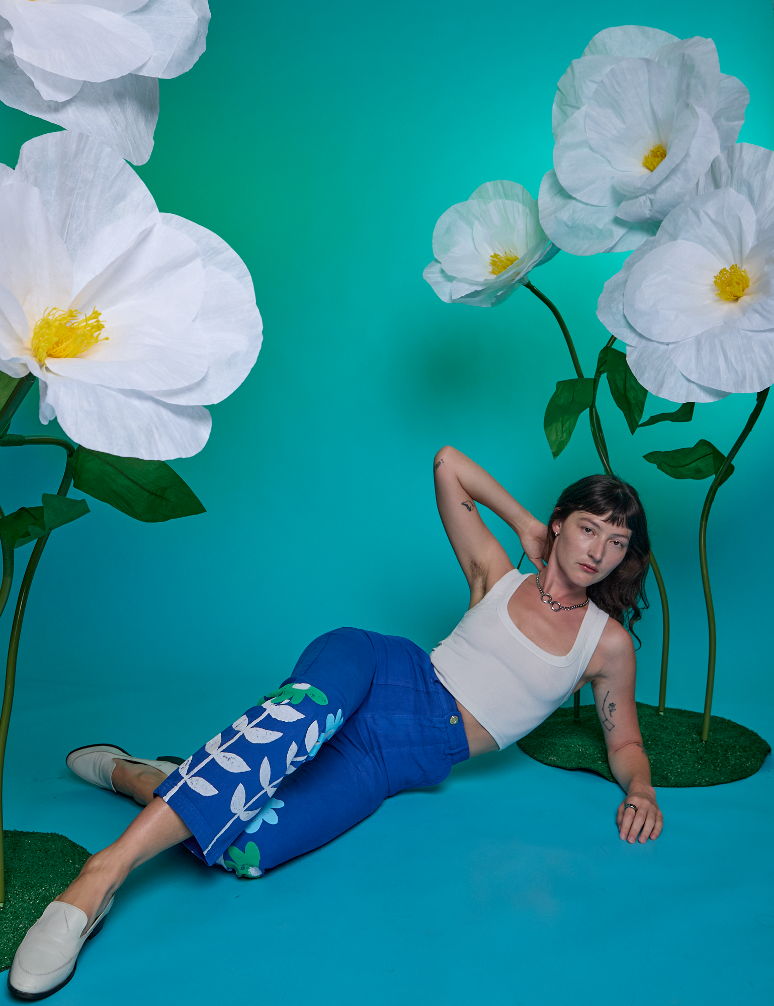 Alex is wearing Paintstamped Work Pants in Daisy and Cropped Tank in Vintage Tee White