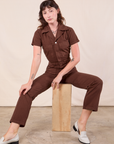 Alex is wearing Short Sleeve Jumpsuit in Fudgesicle Brown