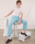 Work Pants in Baby Blue on Quinn sitting on a column