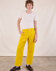 Quinn is 6’4” and wearing M Work Pants in Golden Yellow paired with a Burly Tee in Vintage Tee Off-White