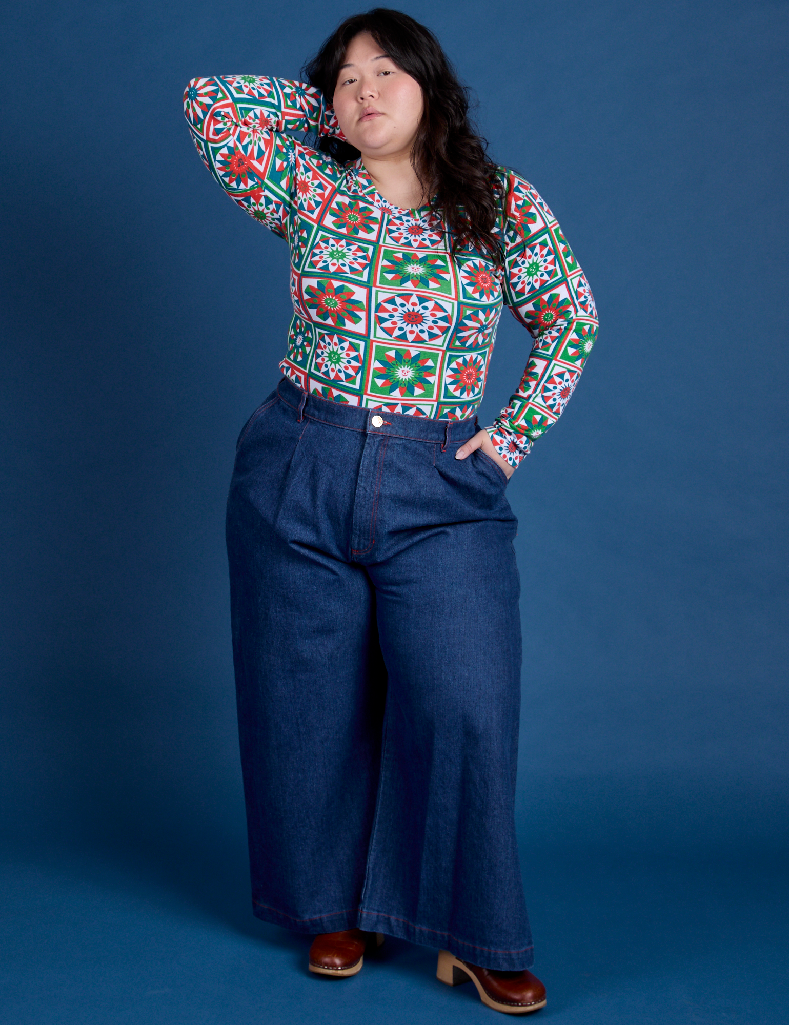 Ashley is wearing Long Sleeve Baby Tee in Quilt Print tucked into dark wash Indigo Wide Leg Trousers