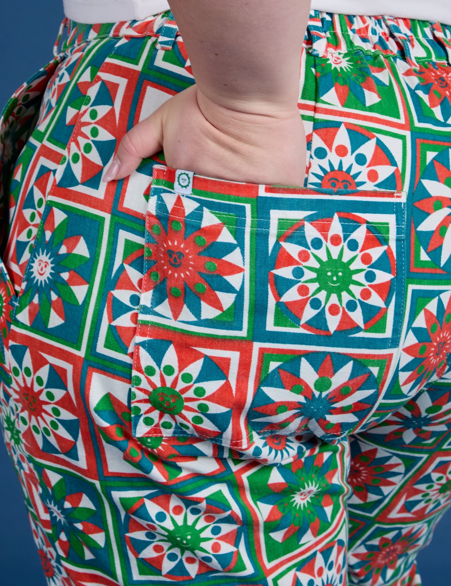 Close up of Ashley&#39;s hand in the back pocket of Work Pants in Quilt Print