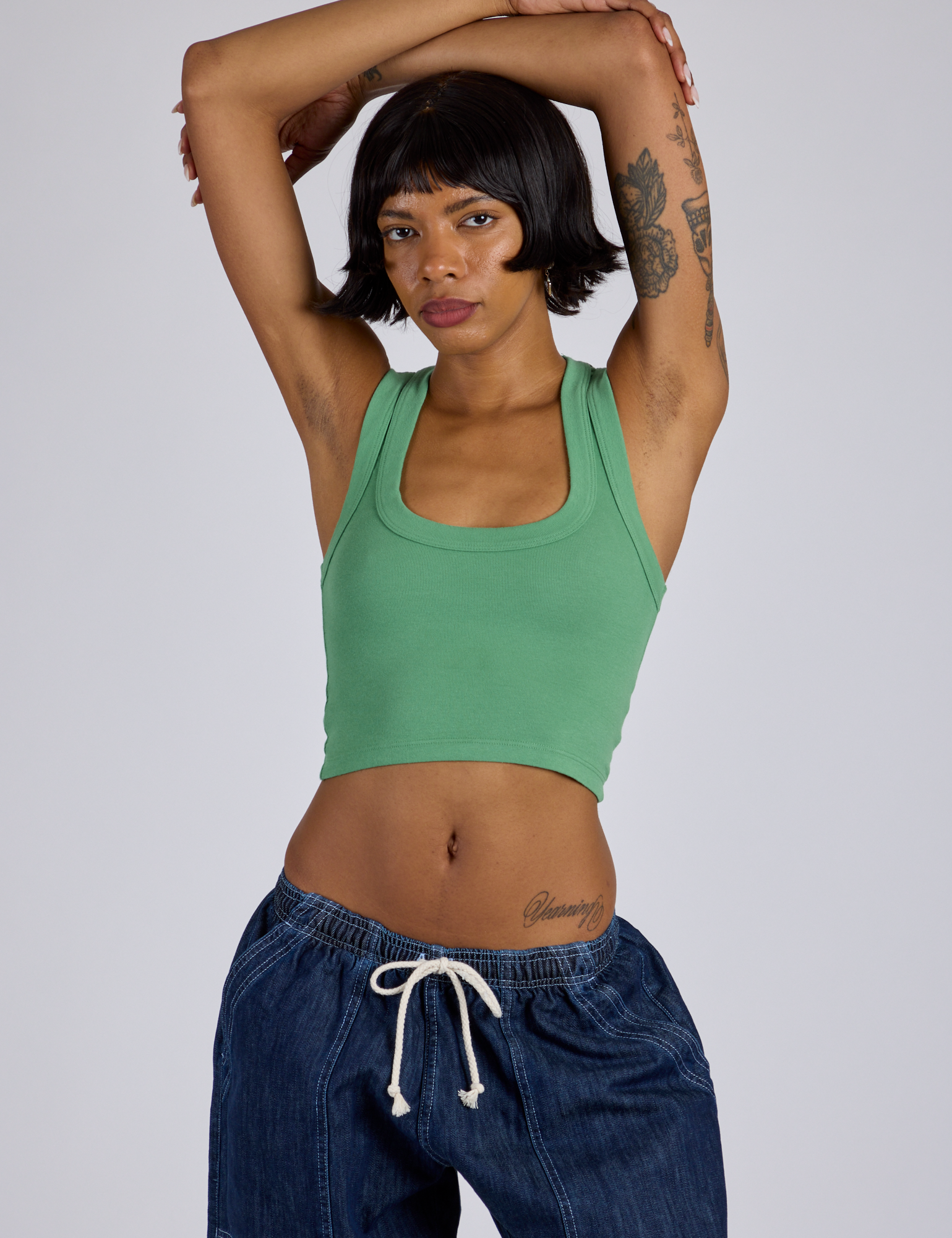 Kira is 5’10” and wearing P  Tank Top in Seafoam Green