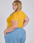 Angled back view of Jr. Varsity Tee in Sunshine Yellow on Juliet