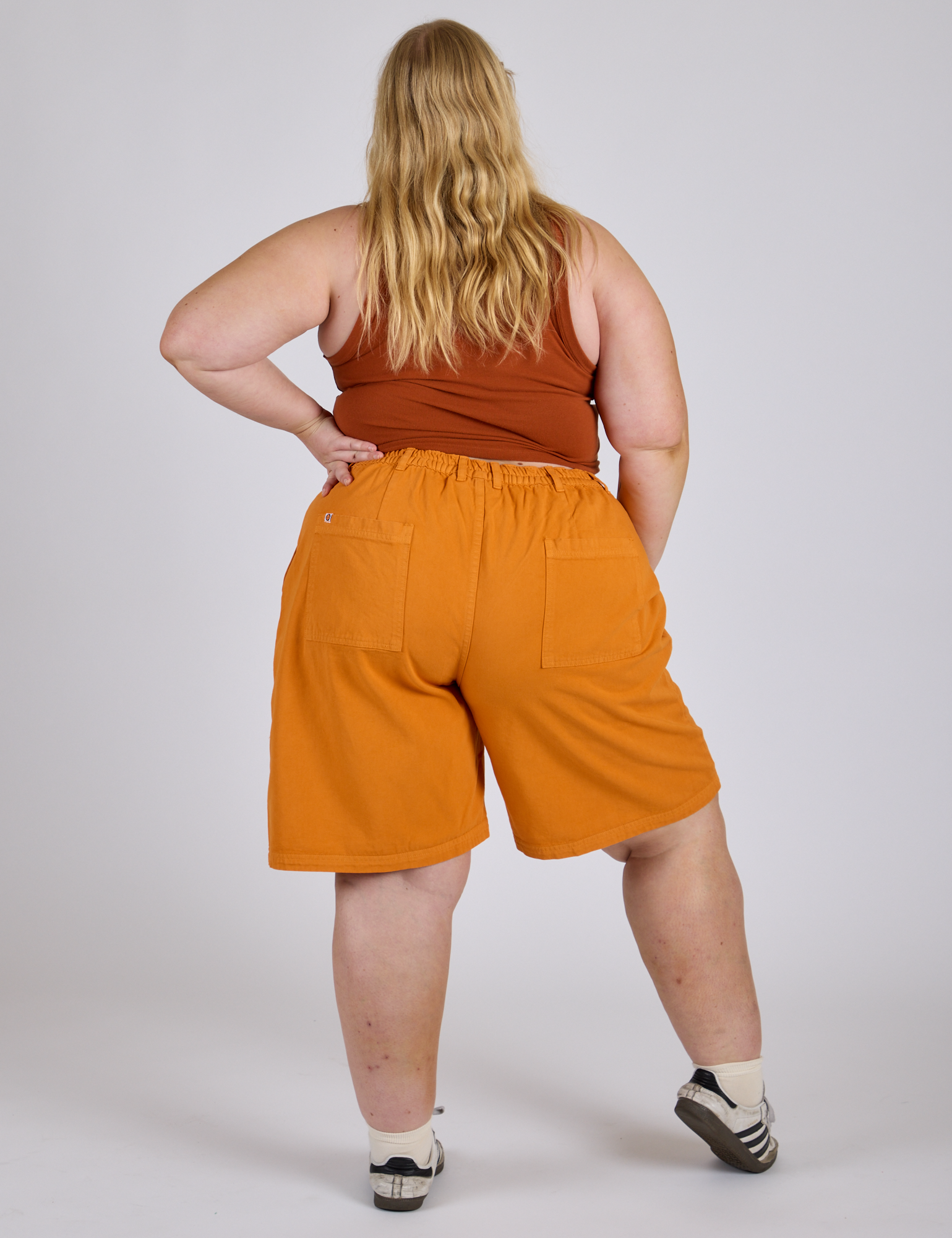 Longline Work Shorts in Creamsicle Orange back view on Juliet