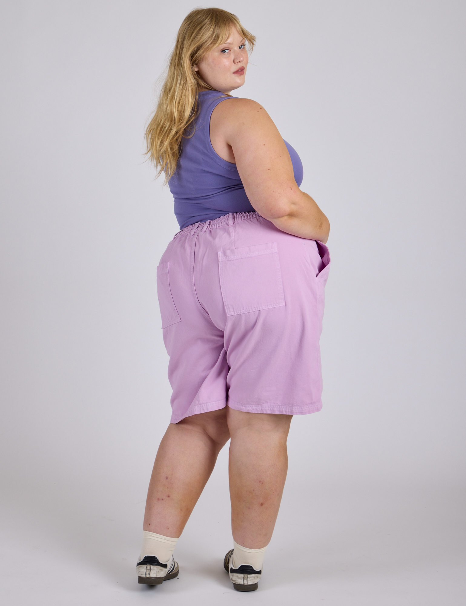 Angled back view of Longline Work Shorts in Lilac Purple on Juliet