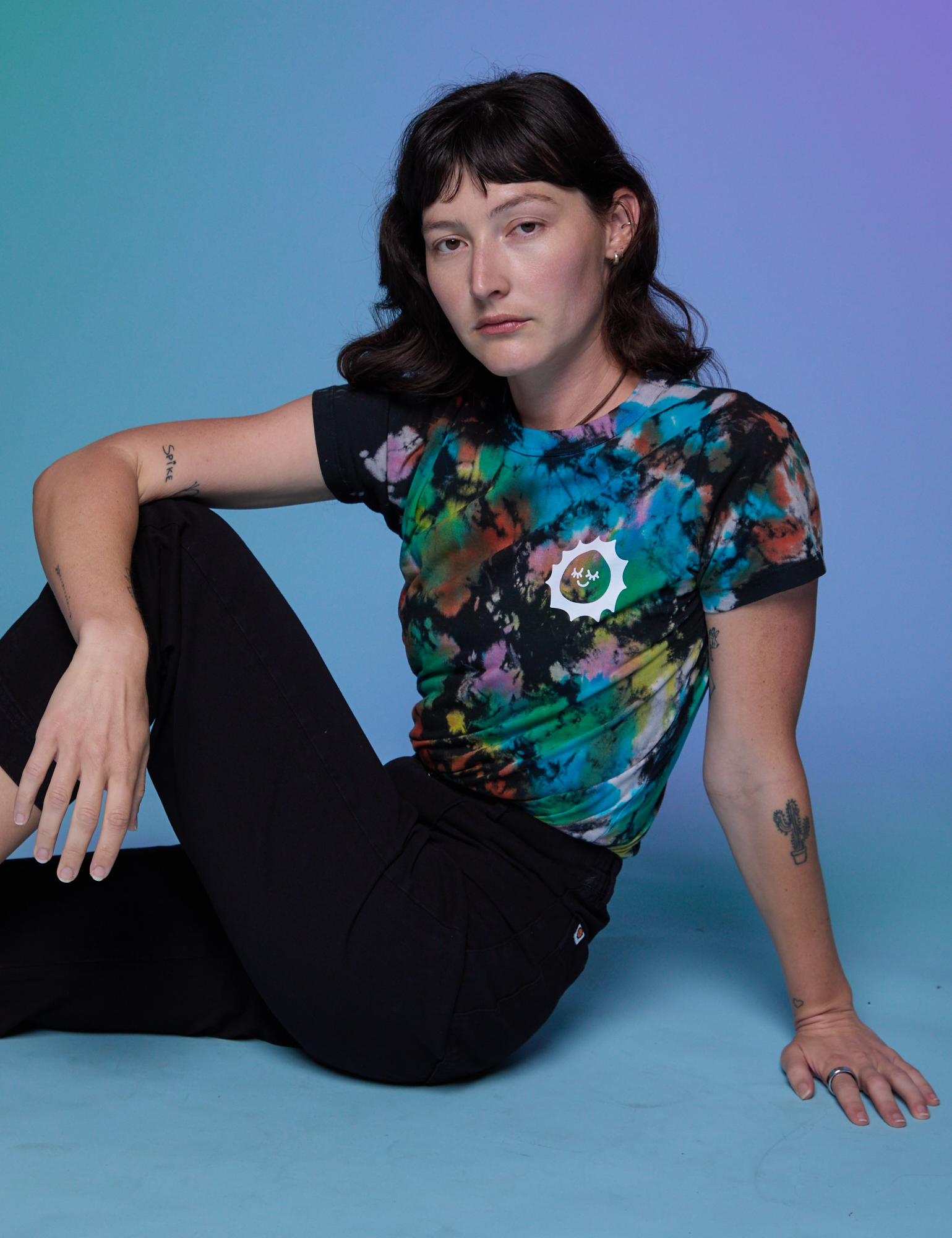 Alex is wearing Classic Tee in Rainbow Magic Waters