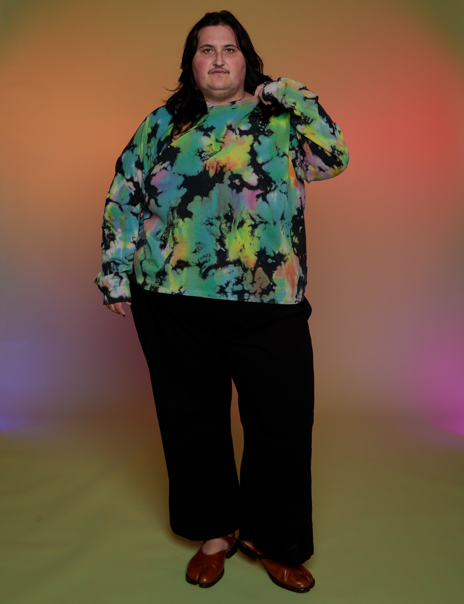 Sam is wearing Magic Waters Long Sleeve Burly Tee in Rainbow