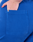 Work Pants in Royal Blue back pocket close up with Juliet's hand in the pocket