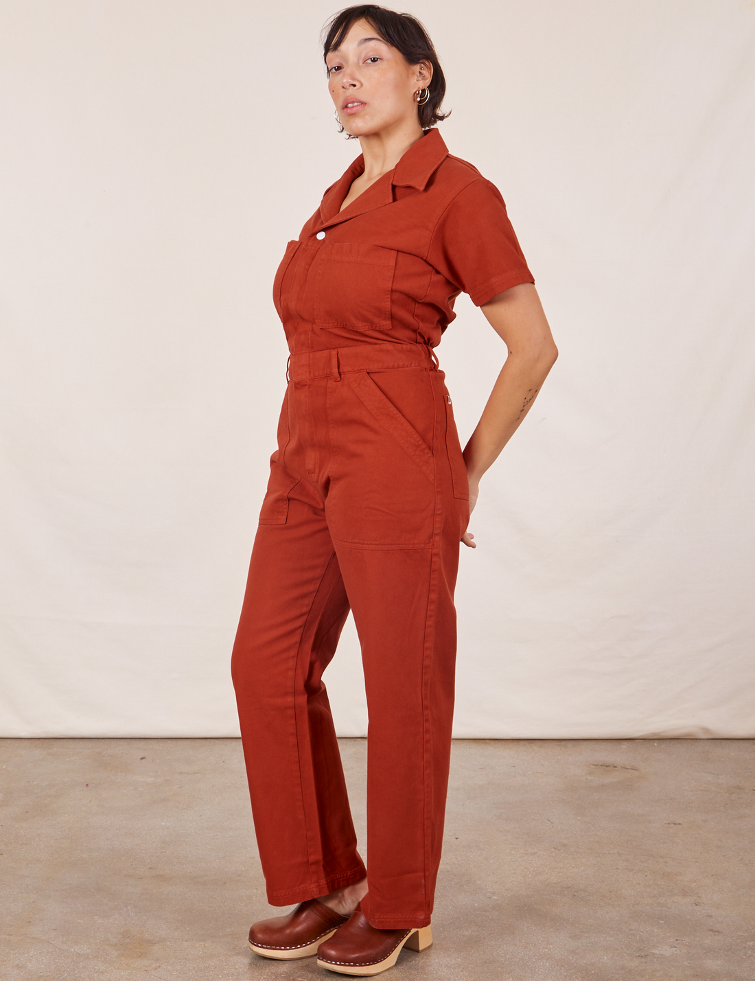 Angled view of Short Sleeve Jumpsuit in Paprika worn by Tiara