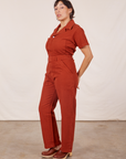 Angled view of Short Sleeve Jumpsuit in Paprika worn by Tiara