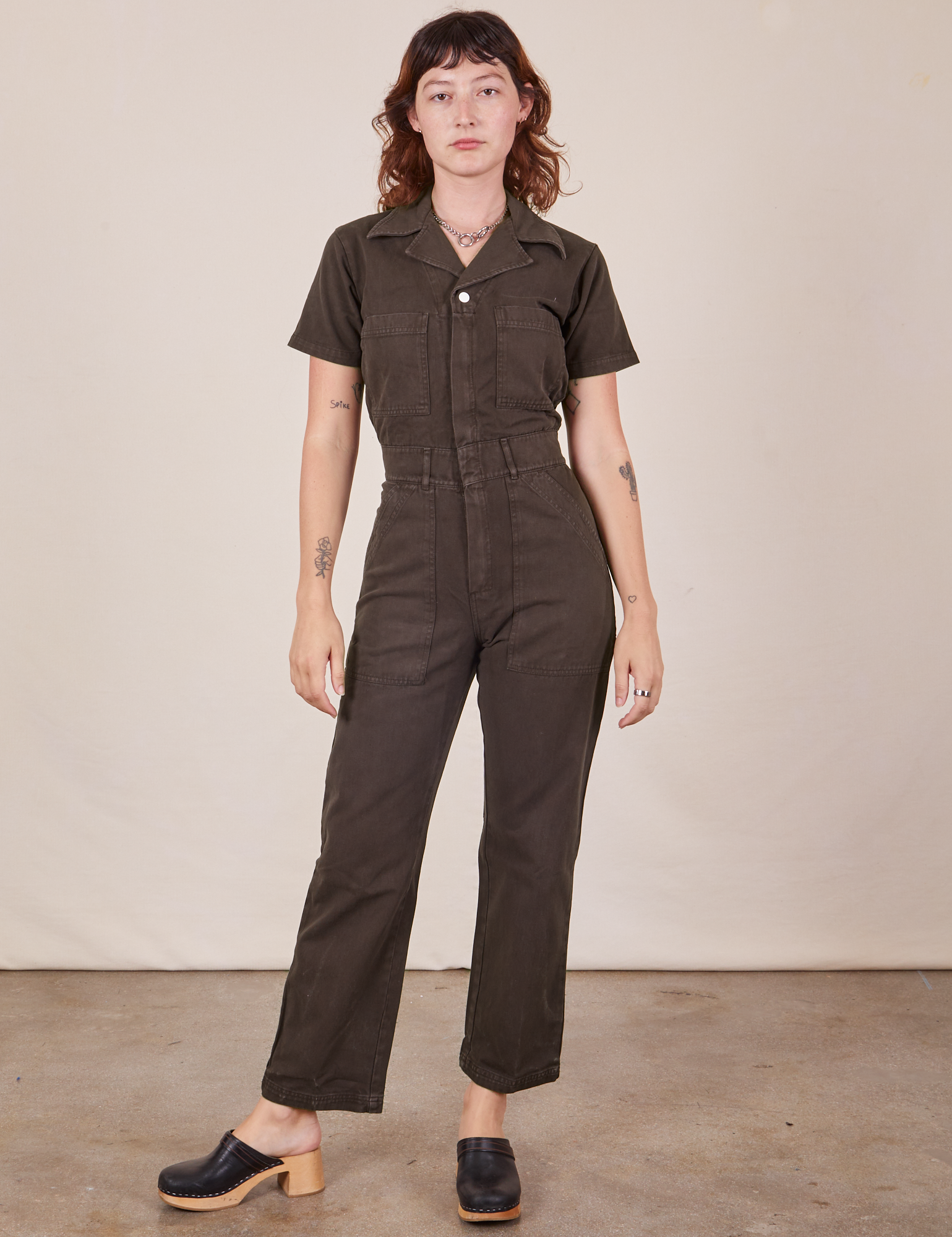 Alex is 5&#39;8&quot; and wearing XS Short Sleeve Jumpsuit in Espresso Brown