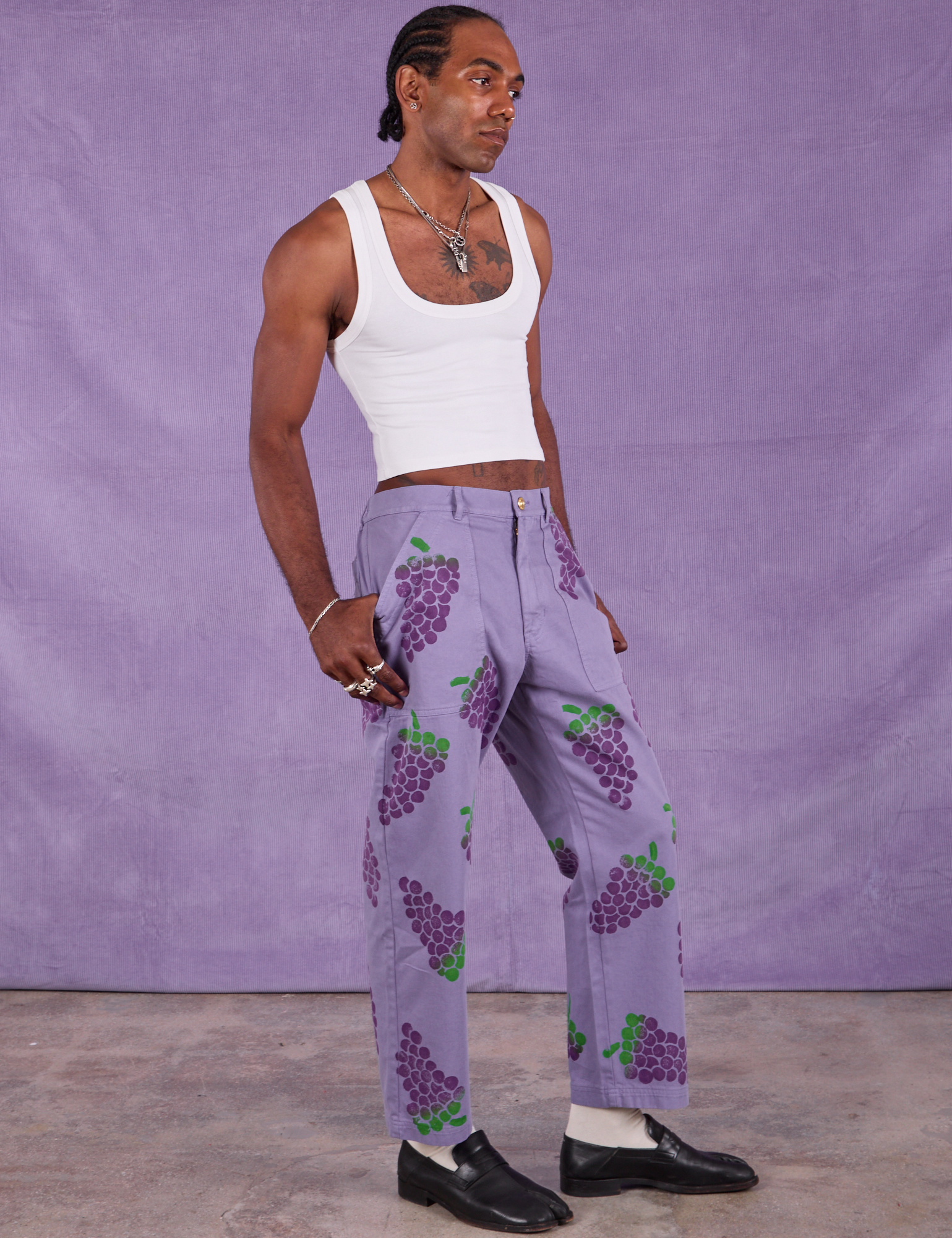 Angled front view of Paintstamped Work Pants in Grape and Cropped Tank in Vintage Tee Off-White