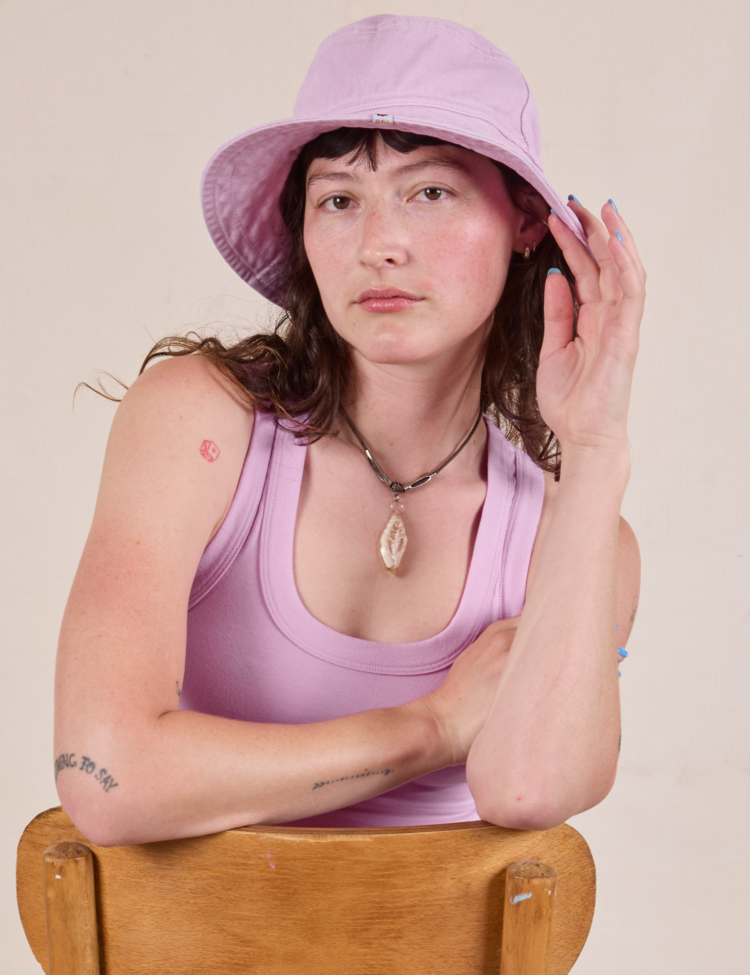 Alex is wearing Wide Brim Denim Bucket Hat in Lilac