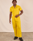 Issac is 5'10" and wearing M Short Sleeve Jumpsuit in Golden Yellow