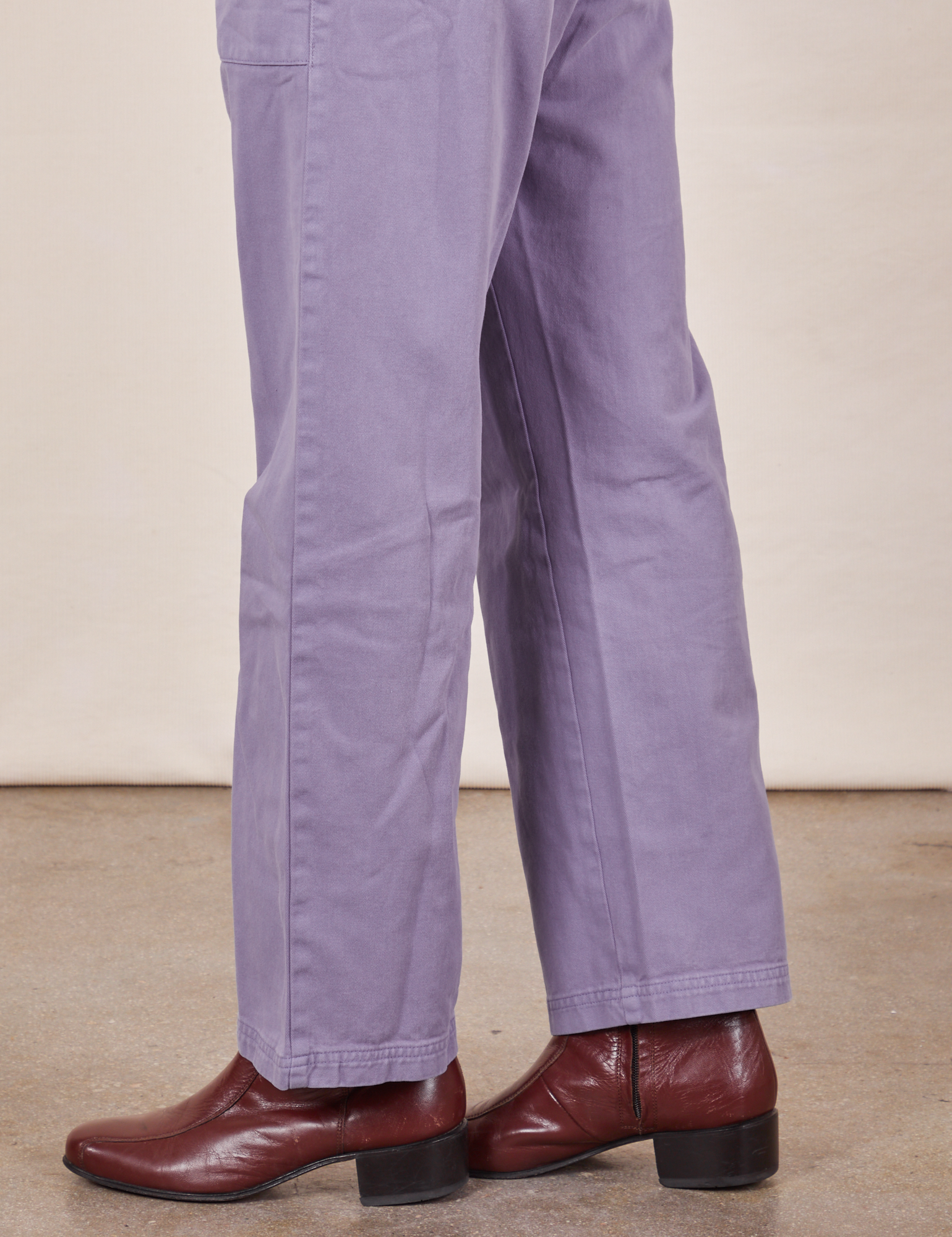 Side view pant leg close up of Short Sleeve Jumpsuit in Faded Grape worn by Jesse