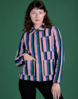 Alex is wearing a buttoned up Stripe Work Jacket in Pacific Stripe