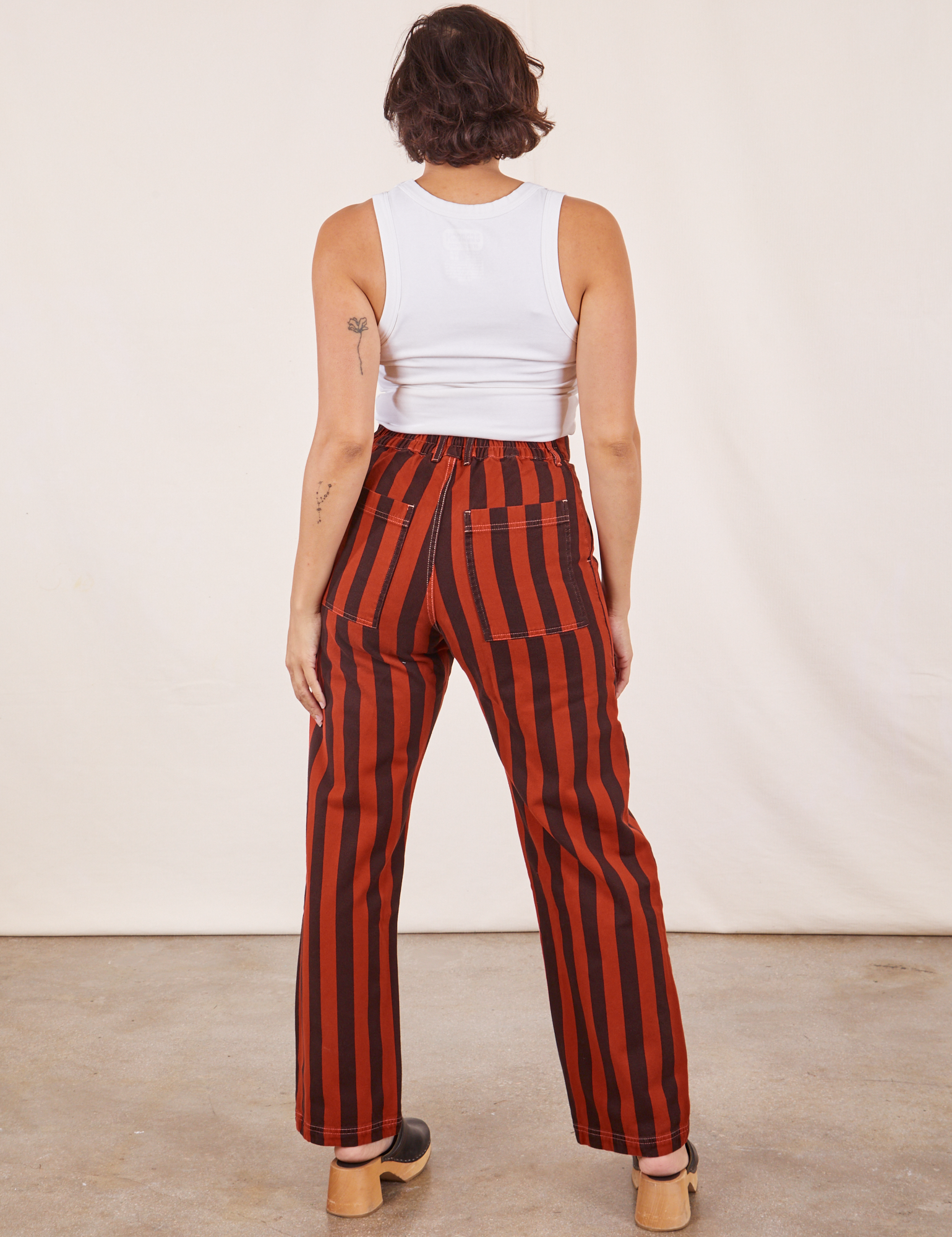 Back view of Black Striped Work Pants in Paprika and vintage off-white Cropped Tank Top on Tiara