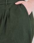 Heritage Trousers in Swamp Green front pocket close up. Ashley has her hand in the pocket.