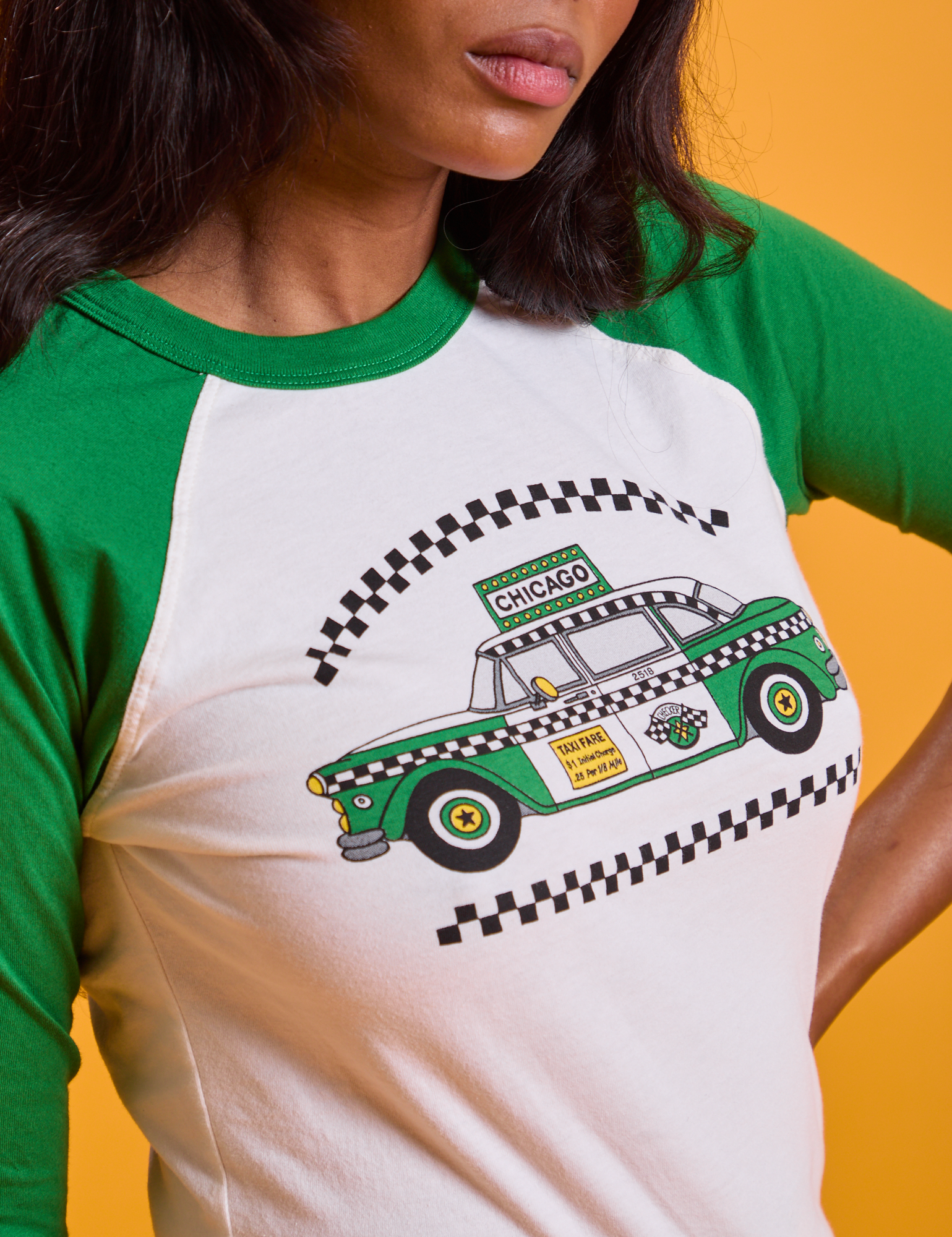 Taxi Raglan Tee in Chicago close up of green taxi graphic on shirt