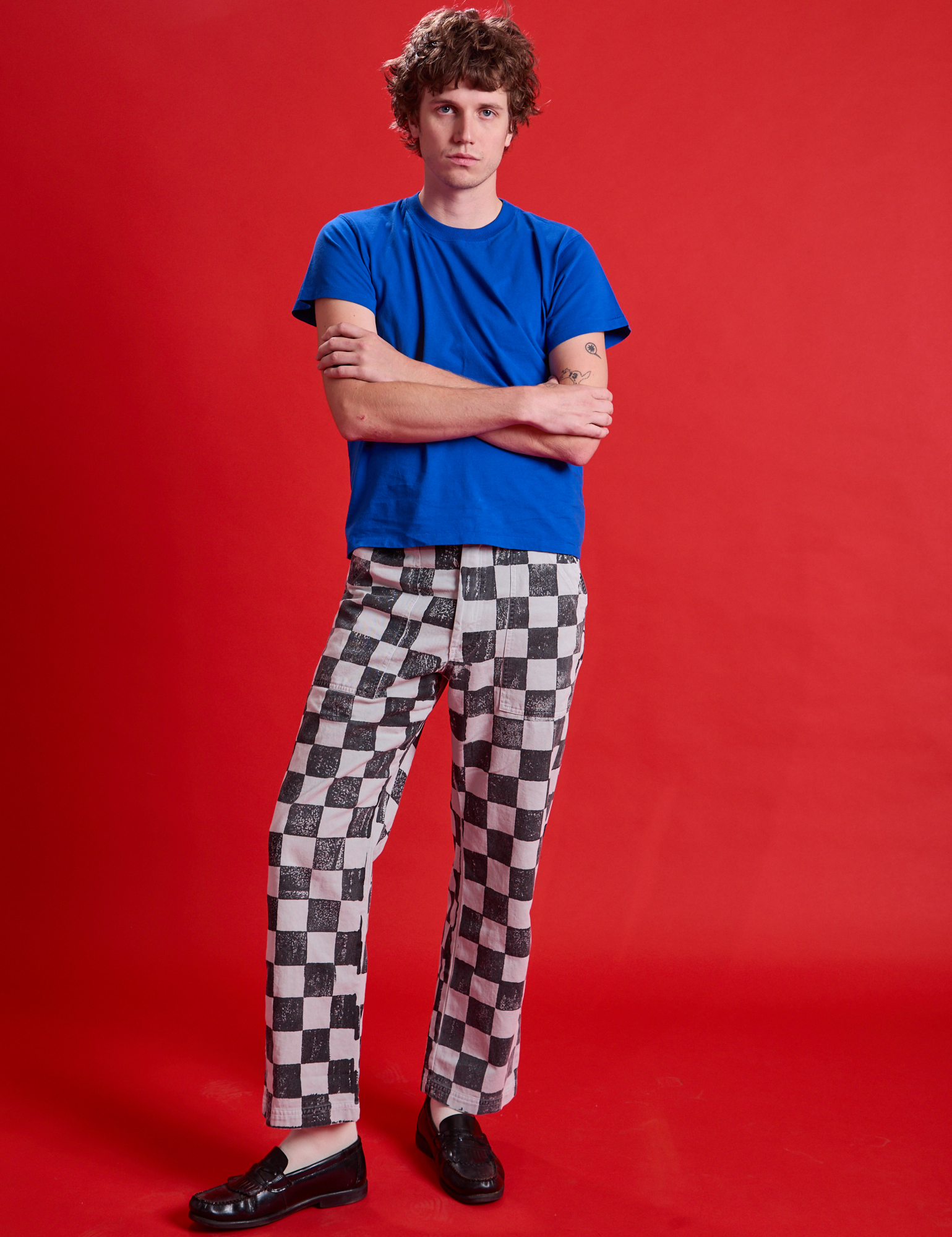 Quinn is 6&#39;3&quot; and wearing M Checkerboard Work Pants in Black/White paired with royal blue Organic Tee