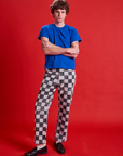 Quinn is 6'3" and wearing M Checkerboard Work Pants in Black/White paired with royal blue Organic Tee