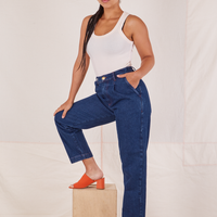 Angled view of Denim Trouser Jeans in Dark Wash and vintage off-white Tank Top worn by Gabi