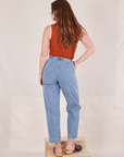 Back view of Denim Trouser Jeans in Light Wash and burnt orange Tank Top worn by Allison
